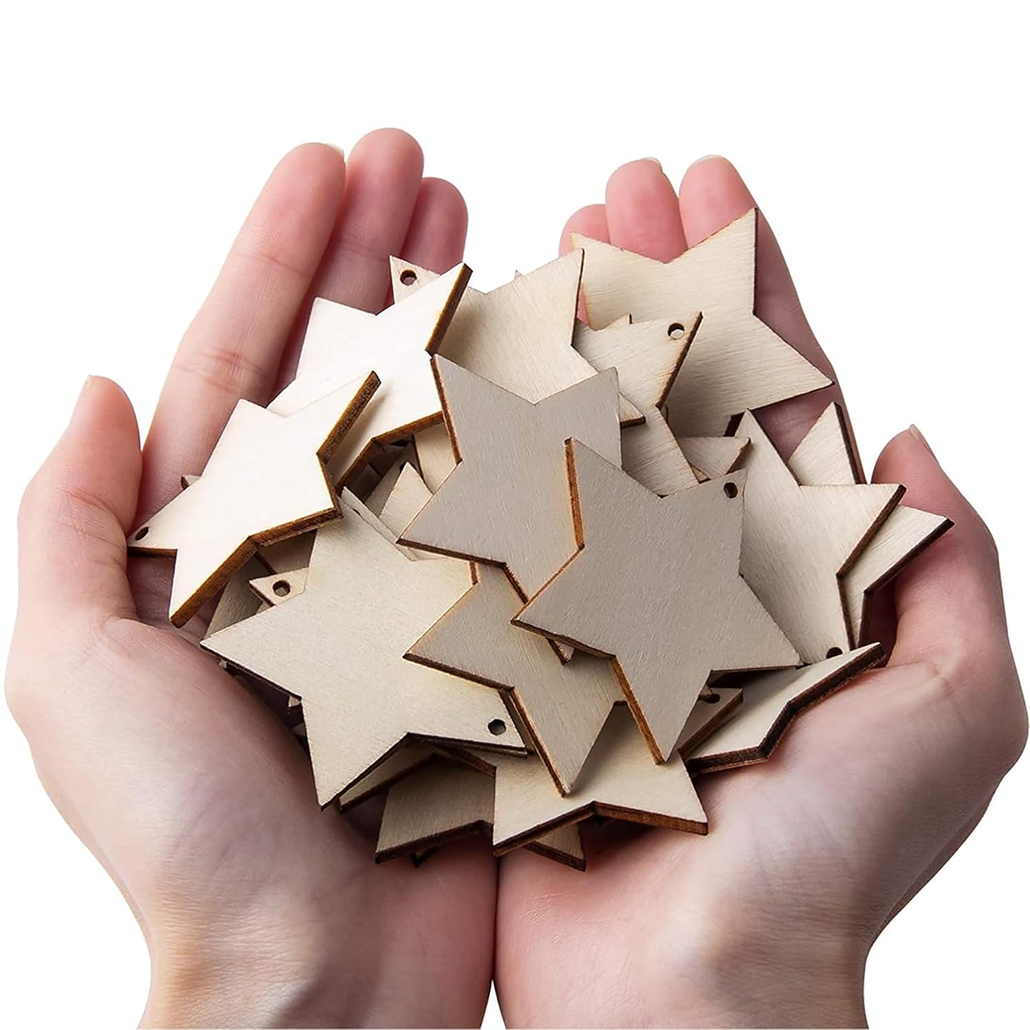Hands holding a pile of wooden star-shaped ornaments on a white background