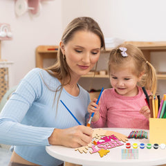 Woman and child engaged in a craft activity with letters and paint.