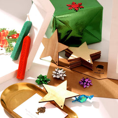 Decorative stars and gift wrap on a white surface