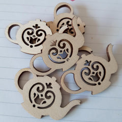 Wooden monkey shapes with cut-out designs on a white background