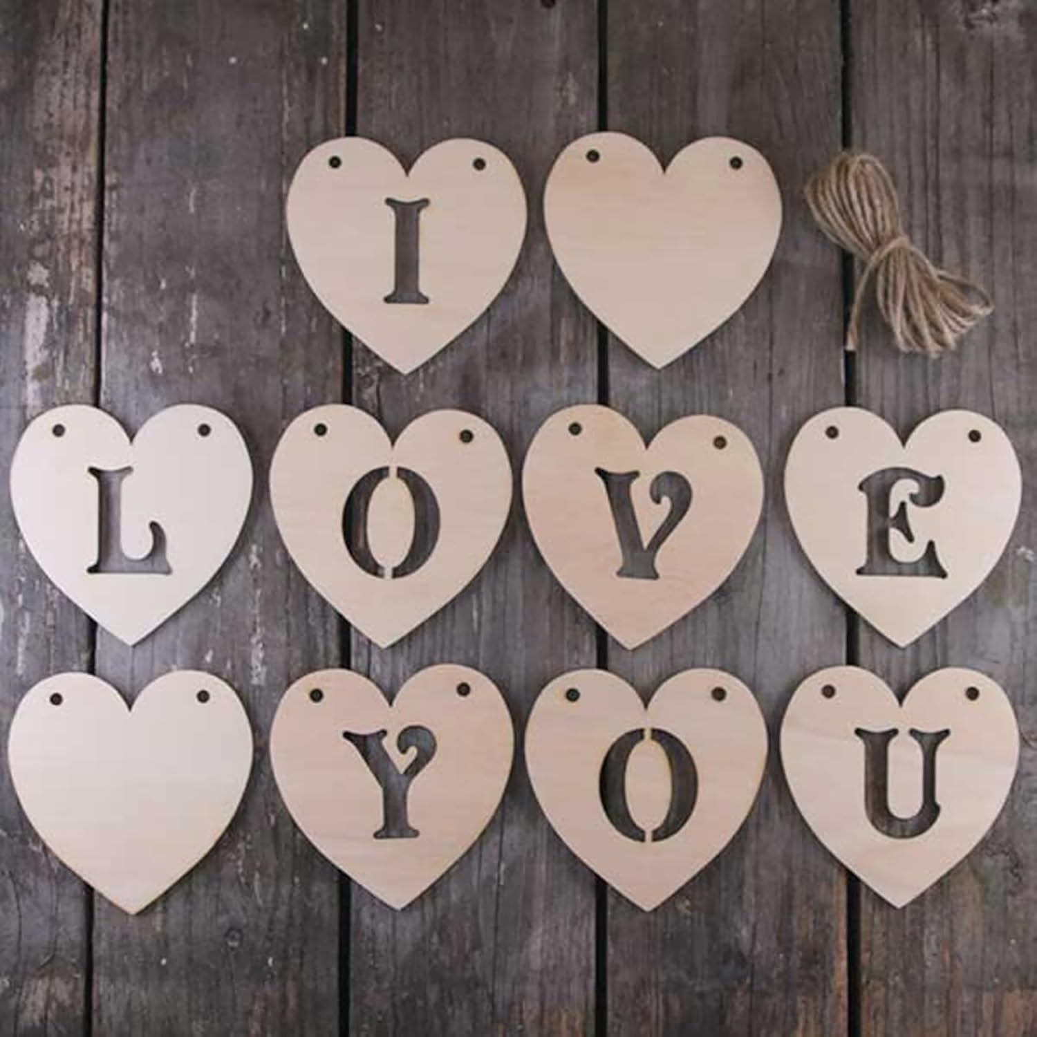 Wooden heart-shaped letters spelling 'I LOVE YOU' on a wooden background