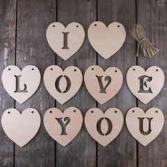 Wooden heart-shaped letters spelling 'I LOVE YOU' on a wooden background