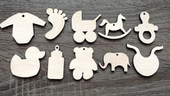 Set of wooden baby-themed ornaments on a wooden surface