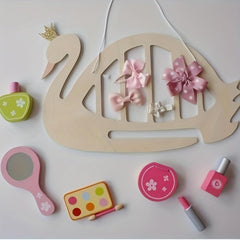 Wooden swan with decorative bows and small cosmetic items on a light background