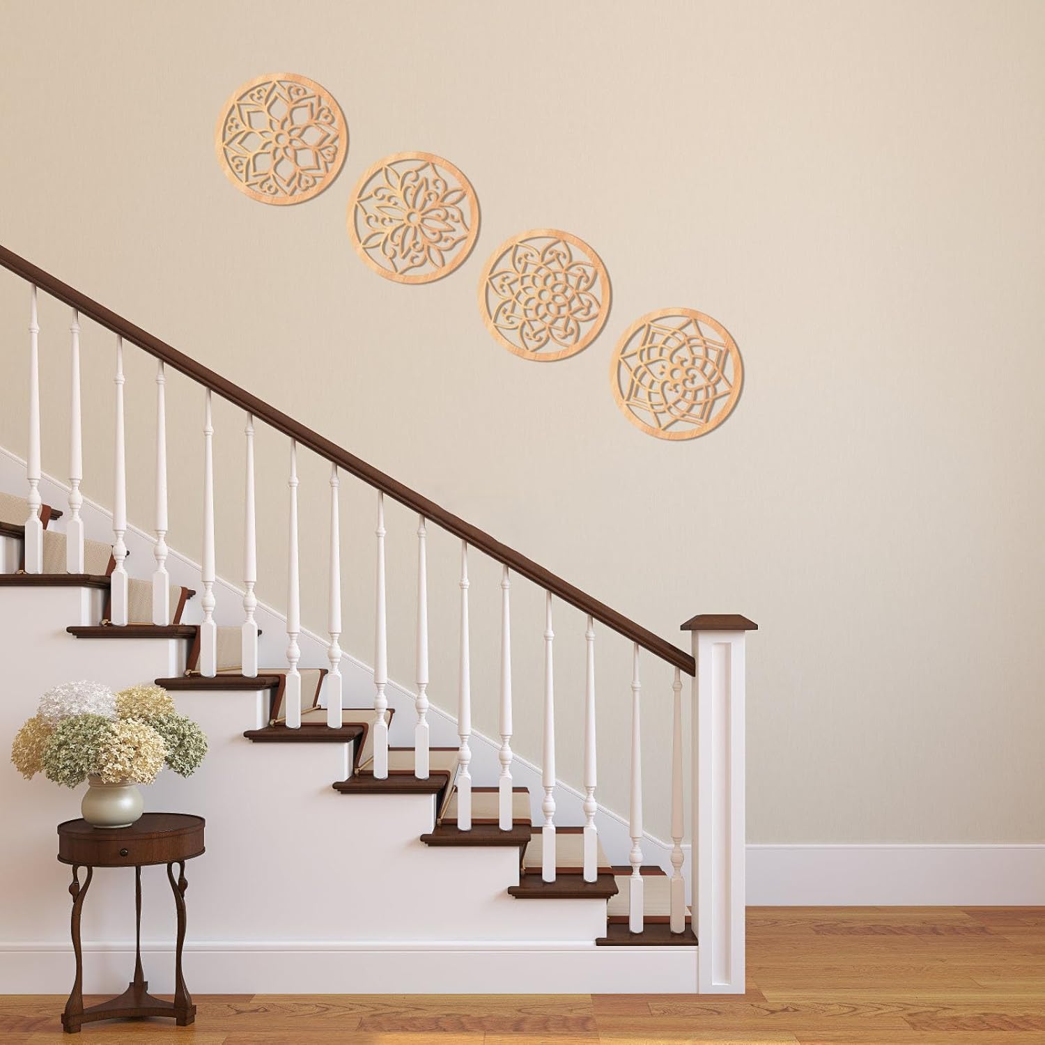 Decorative wall stickers on a wall above a staircase with a side table and flowers.