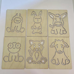 Six wooden cutouts of cartoon animals on a white background