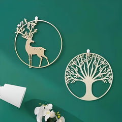 Decorative wall art pieces with deer and tree designs on a green background
