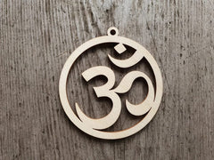 Wooden pendant with Om symbol on a wooden background