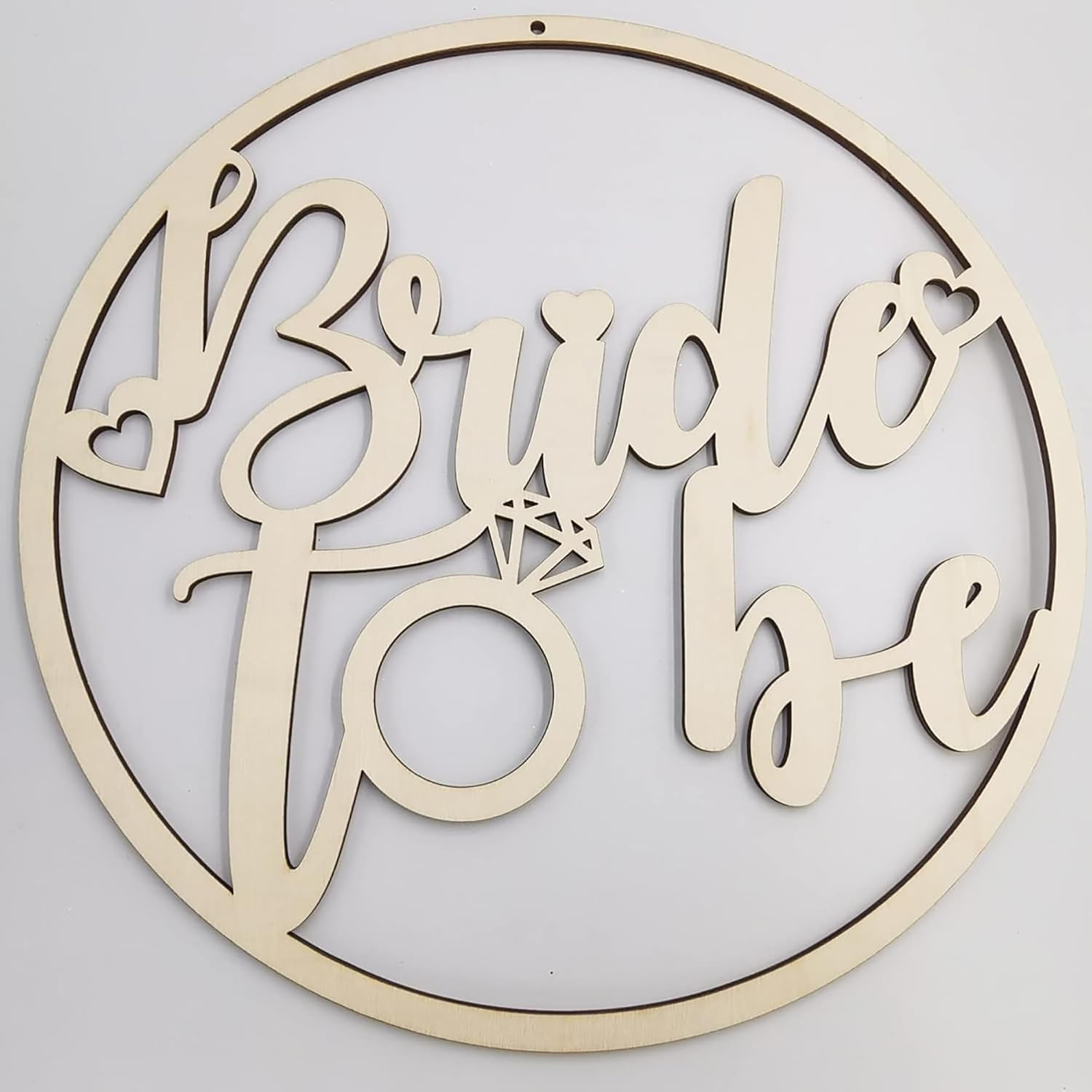 Wooden decorative sign with 'Bride to be' text and a diamond ring design on a light gray background.