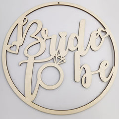 Wooden decorative sign with 'Bride to be' text and a diamond ring design on a light gray background.