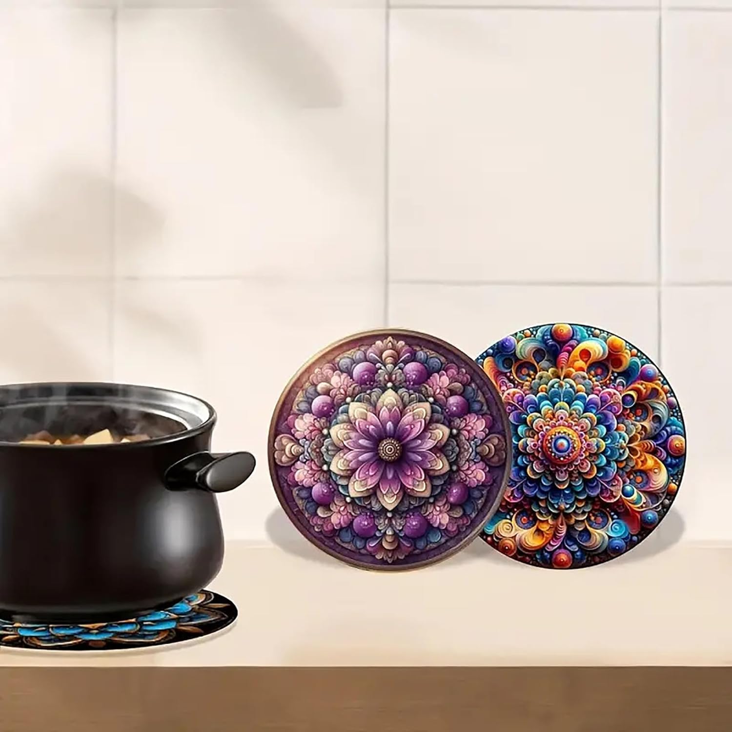 Colorful mandala coasters on a kitchen counter with a pot of food.