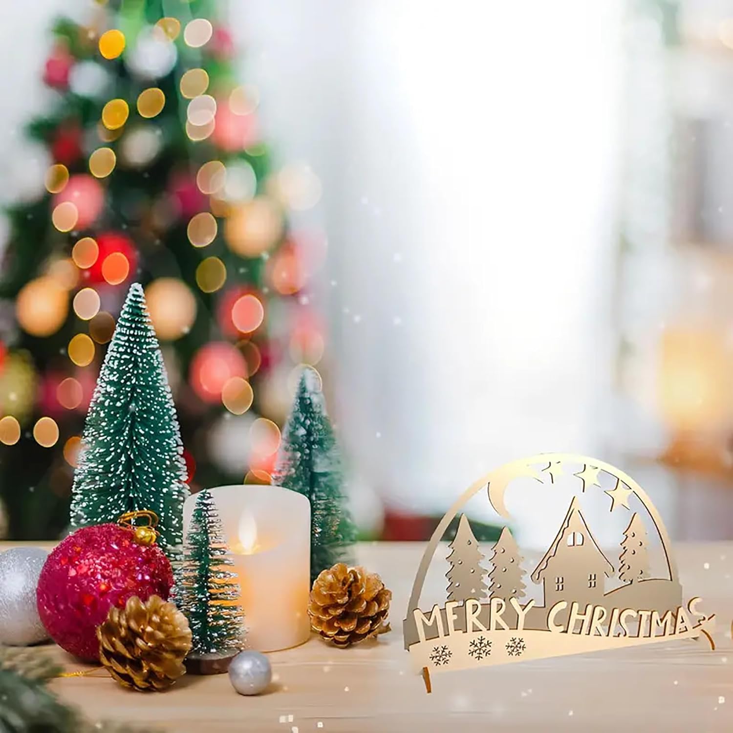 Decorative Christmas scene with small trees, a candle, and a 'Merry Christmas' sign.