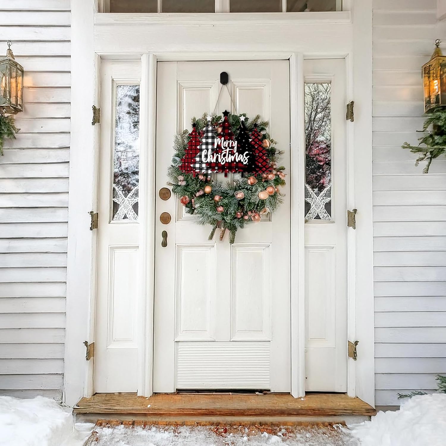 Decorative Christmas wreath on a white door with festive decorations.