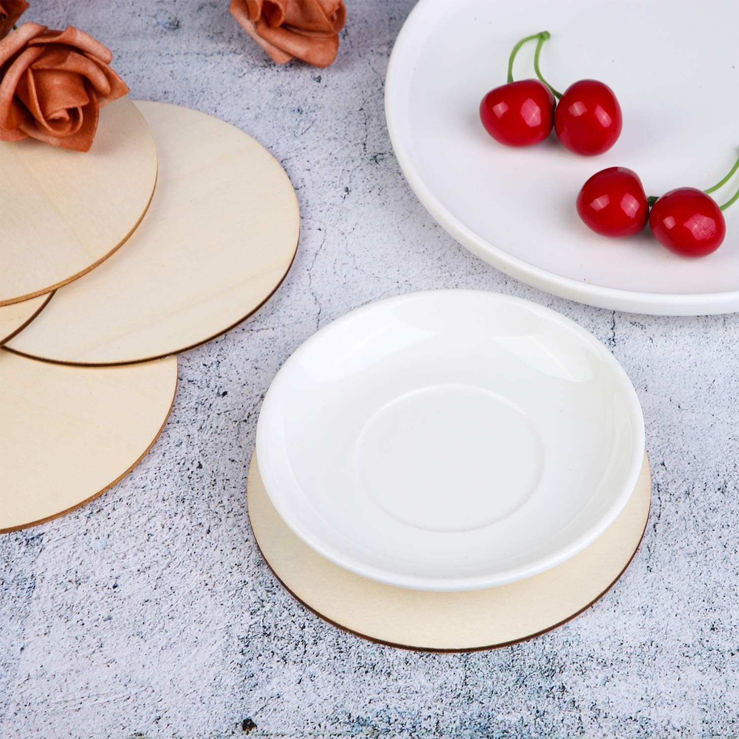 White ceramic plate with gold rim on a textured surface with cherries and flowers.