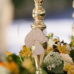 Decorative mushroom tag on a floral arrangement with a blurred background