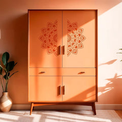 Orange cabinet with mandala designs in a room with a plant and light-colored floor.