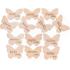 Butterfly-shaped milestone markers with text for baby's first year on a white background
