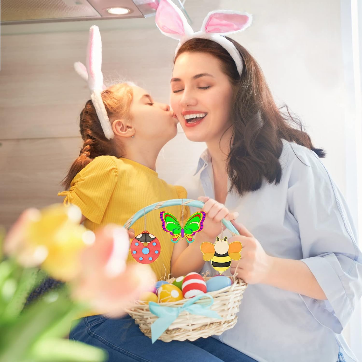 Woman and child wearing bunny ears with an Easter basket filled with eggs and toys.