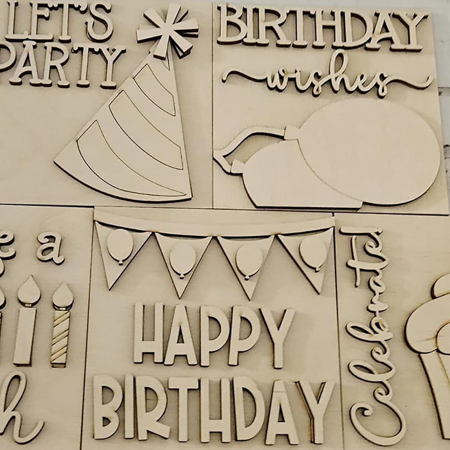 Wooden birthday-themed cutouts with phrases like 'Happy Birthday' and 'Birthday wishes'.