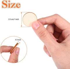 Hand holding a small circular object with measurements on a white background