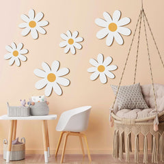Children's room with daisy wall decals, a swing chair, and small table.