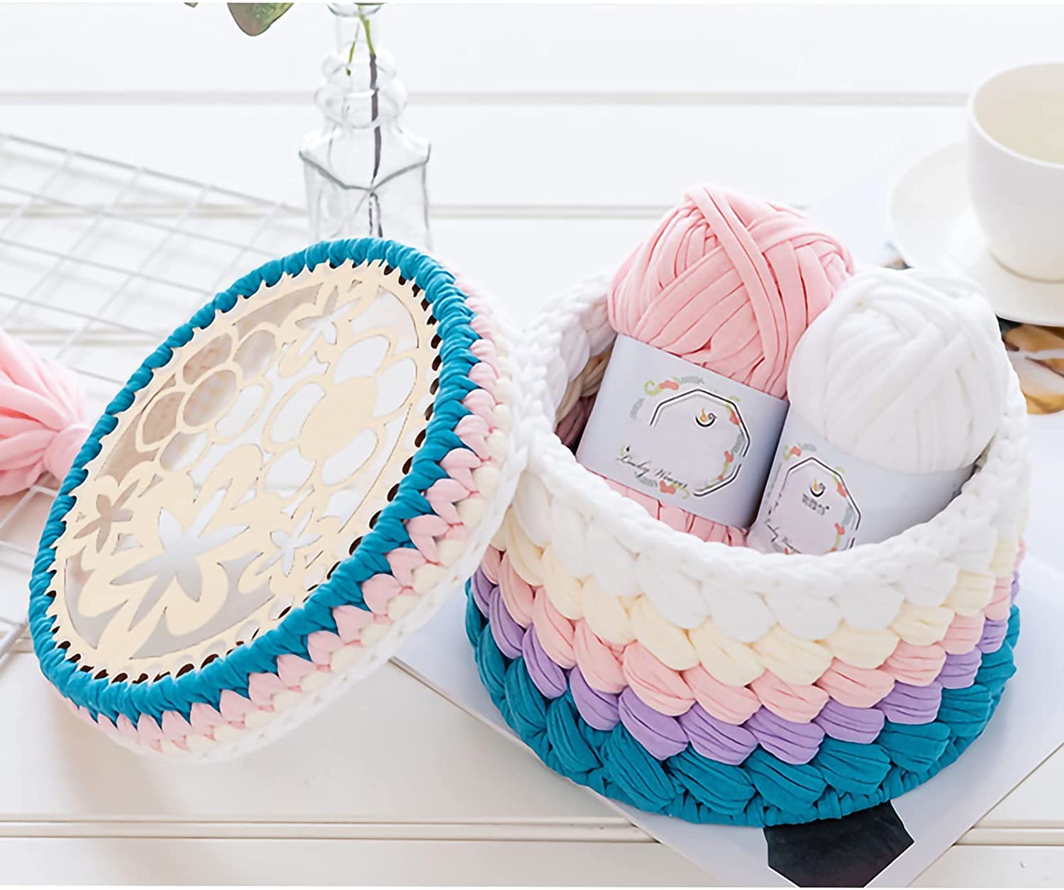 Colorful woven baskets with yarn on a white surface