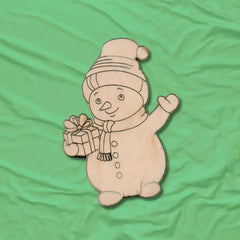 Wooden snowman ornament with a gift on a green fabric background