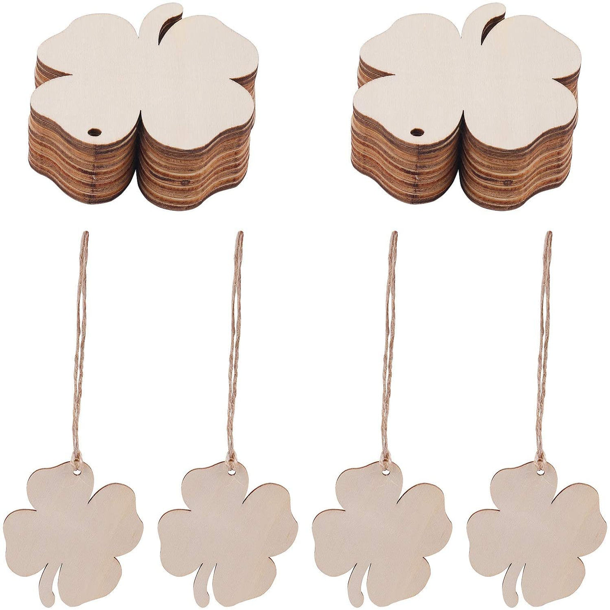 Wooden four-leaf clover tags with strings on a white background