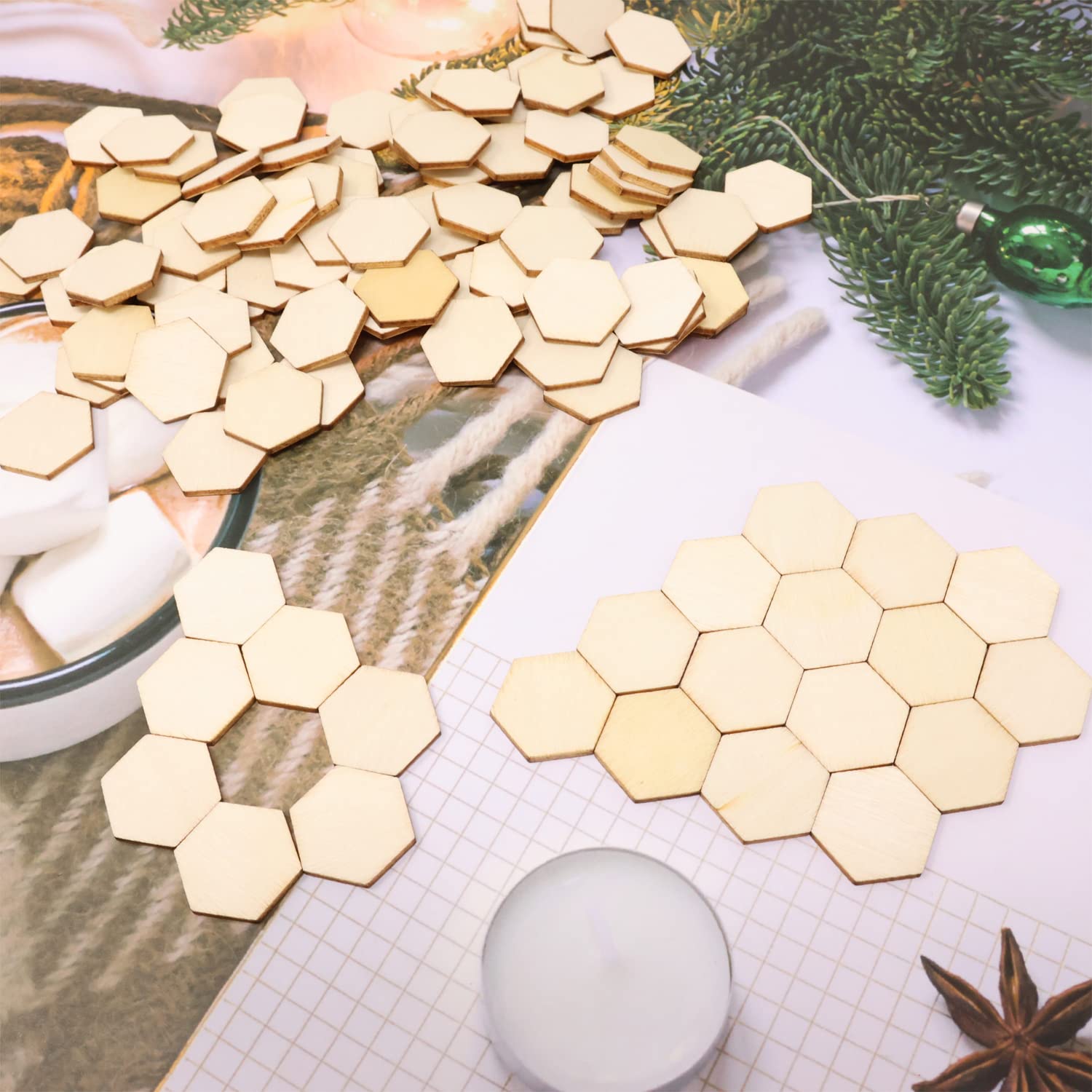 Hexagonal wooden coasters on a surface with a cup of hot chocolate and marshmallows.