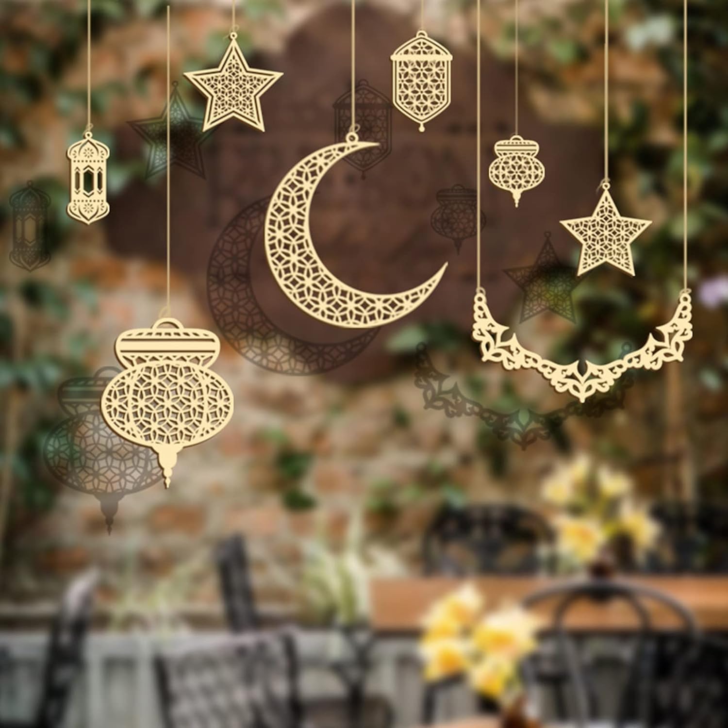 Decorative gold moon, star, and lanterns hanging against a blurred outdoor background.