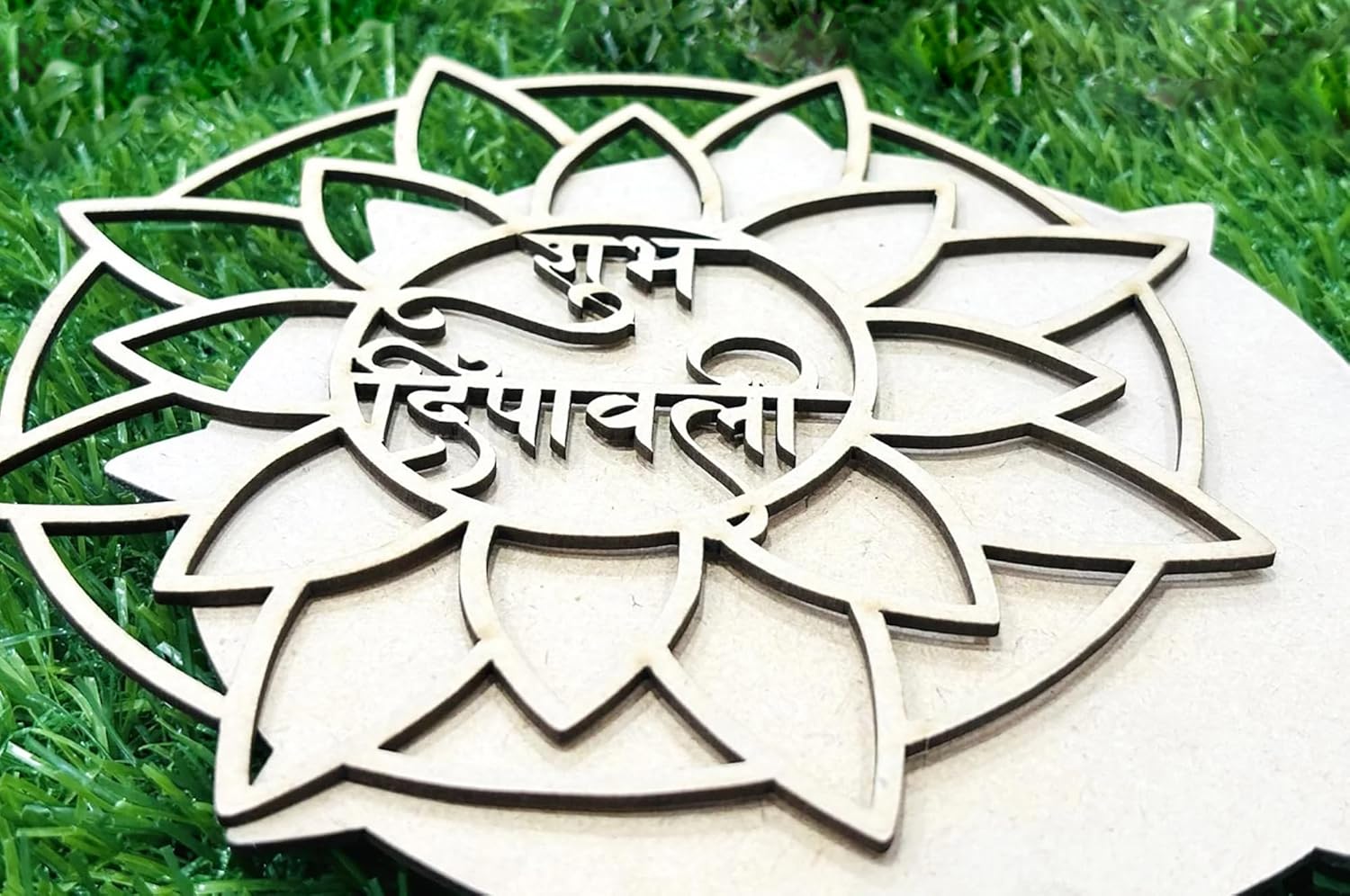 Decorative wooden lotus with engraved text on a grass background