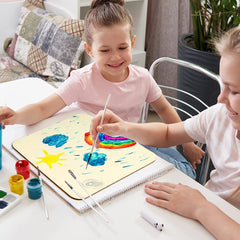 Two children painting a colorful picture together on a table.