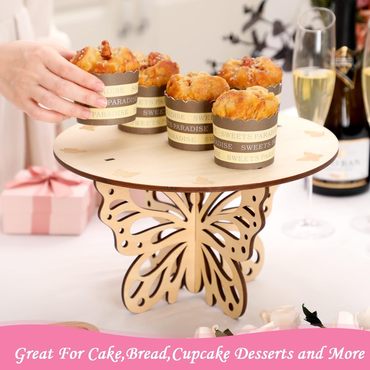 Wooden cake stand with cupcakes on a table with drinks and gifts in the background
