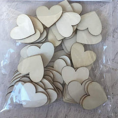 Packaged wooden heart shapes on a textured surface