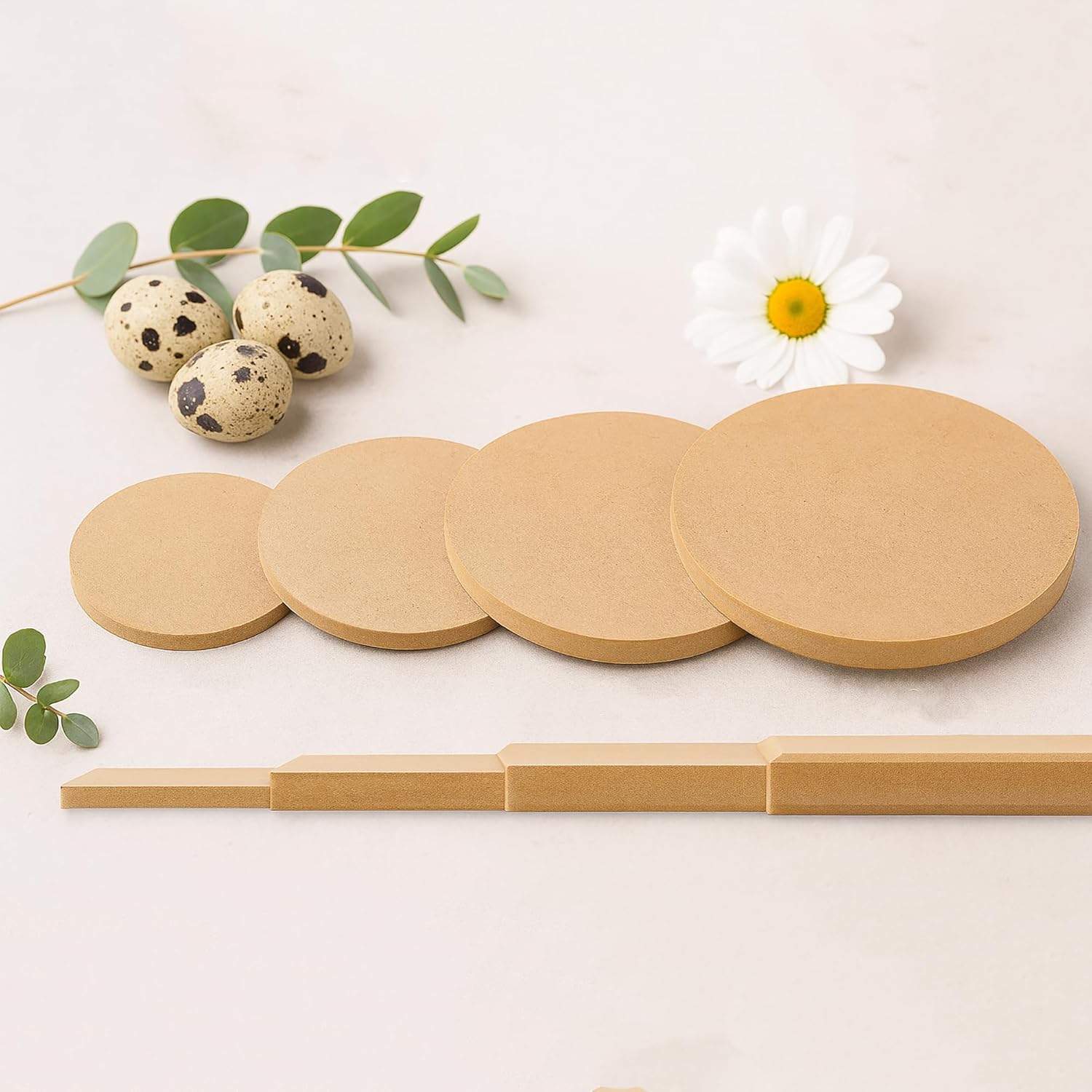 Set of round wooden coasters with a wooden holder on a light background with decorative elements.