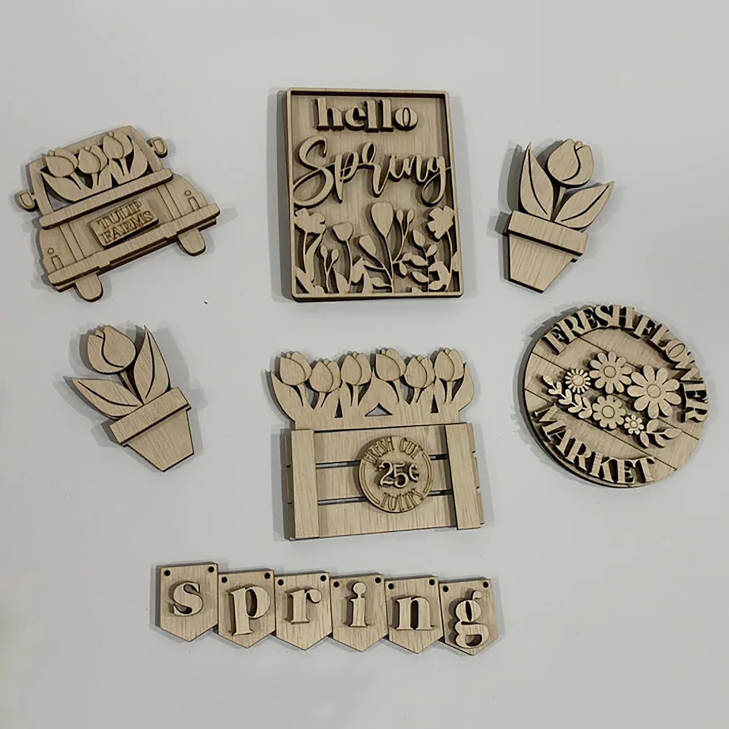 Set of wooden spring-themed decorative pieces on a light gray background