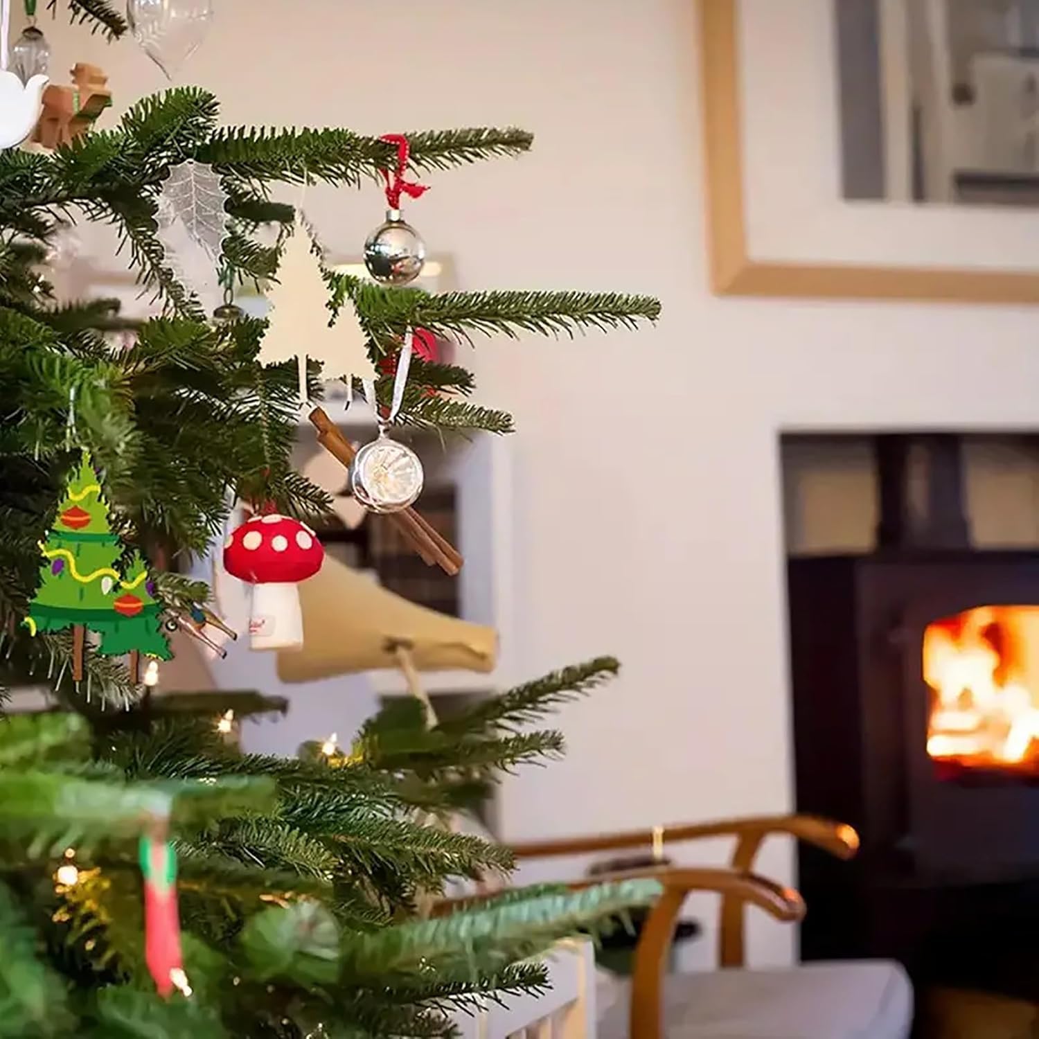 Decorated Christmas tree with ornaments in a living room with a fireplace.
