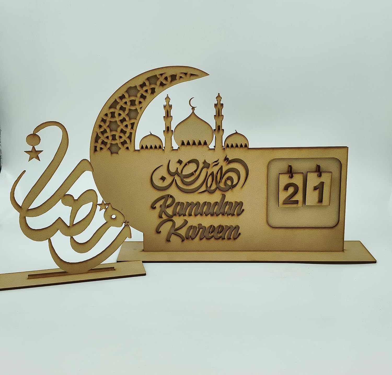 Decorative wooden sign with 'Ramadan Kareem' and a calendar on a white background