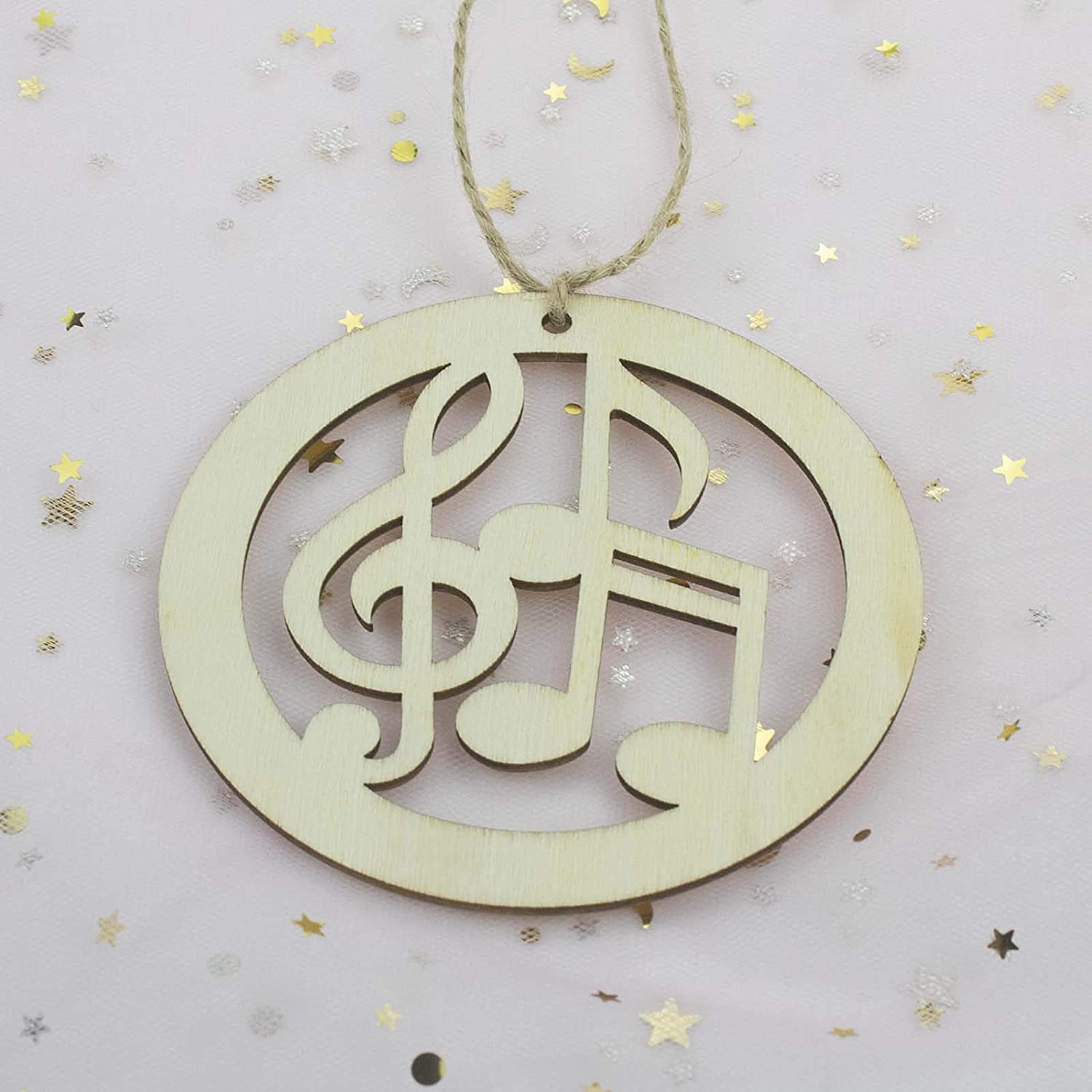 Decorative wooden ornament with musical符号 on a light gray background with gold stars.