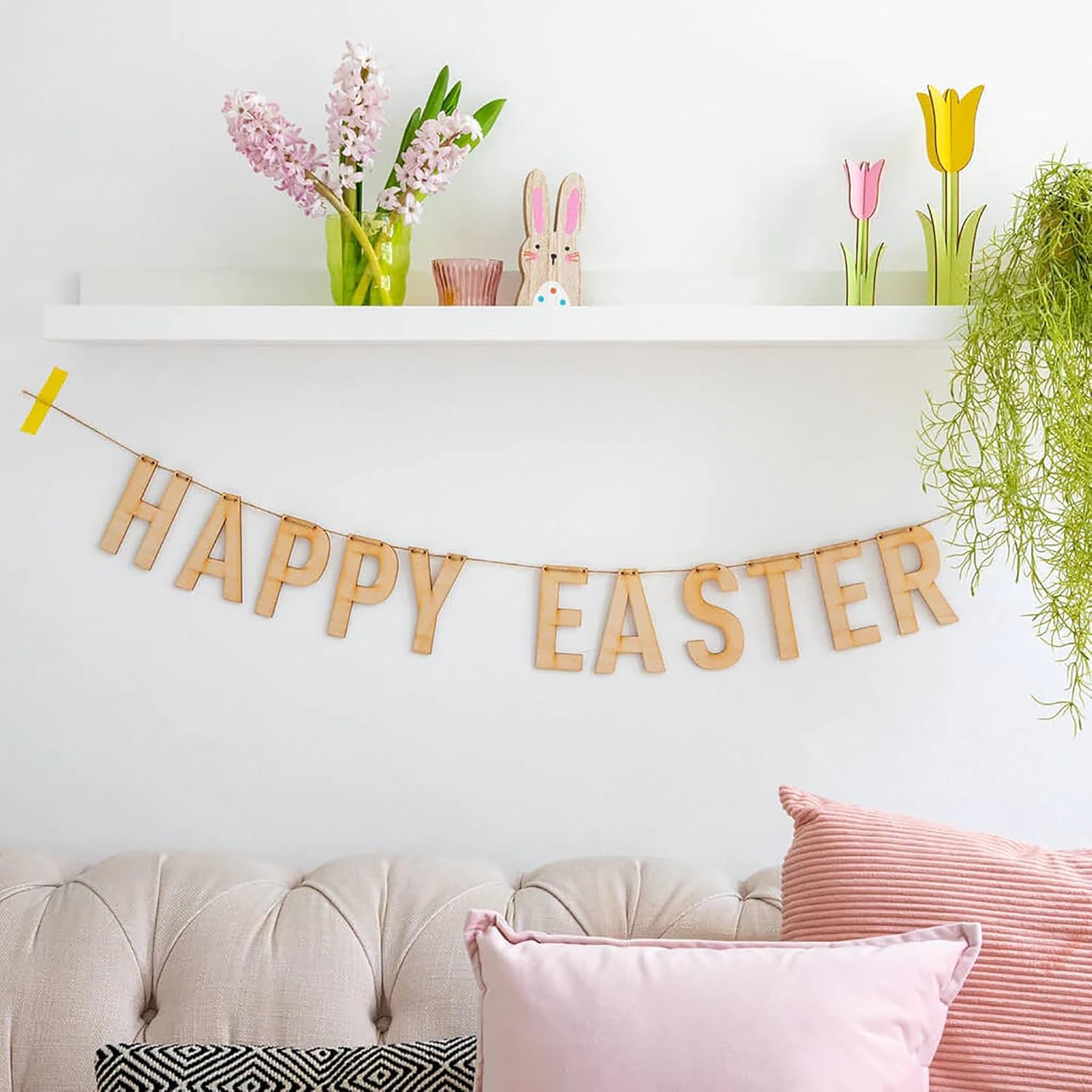 Decorative setup with 'Happy Easter' banner, flowers, and pillows on a couch.