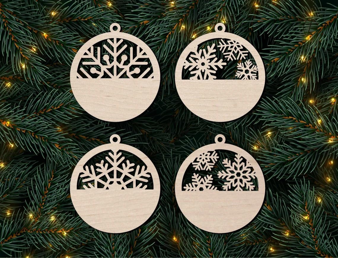 Four wooden Christmas ornaments with snowflake designs on a green branch background.