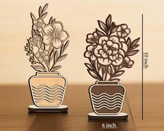 Two decorative potted plants with measurements on a wooden surface