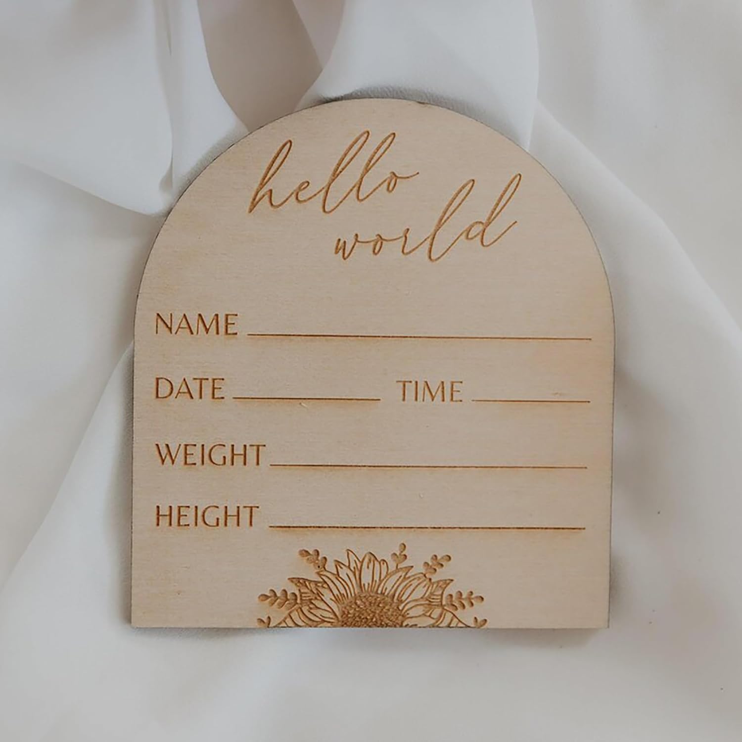 Wooden baby登记board with engraved text and floral design on a white background