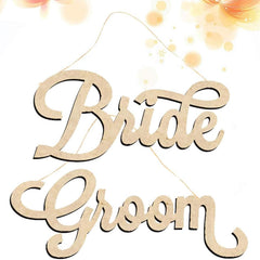 Wooden 'Bride' and 'Groom' signs hanging against a light background with floral elements.
