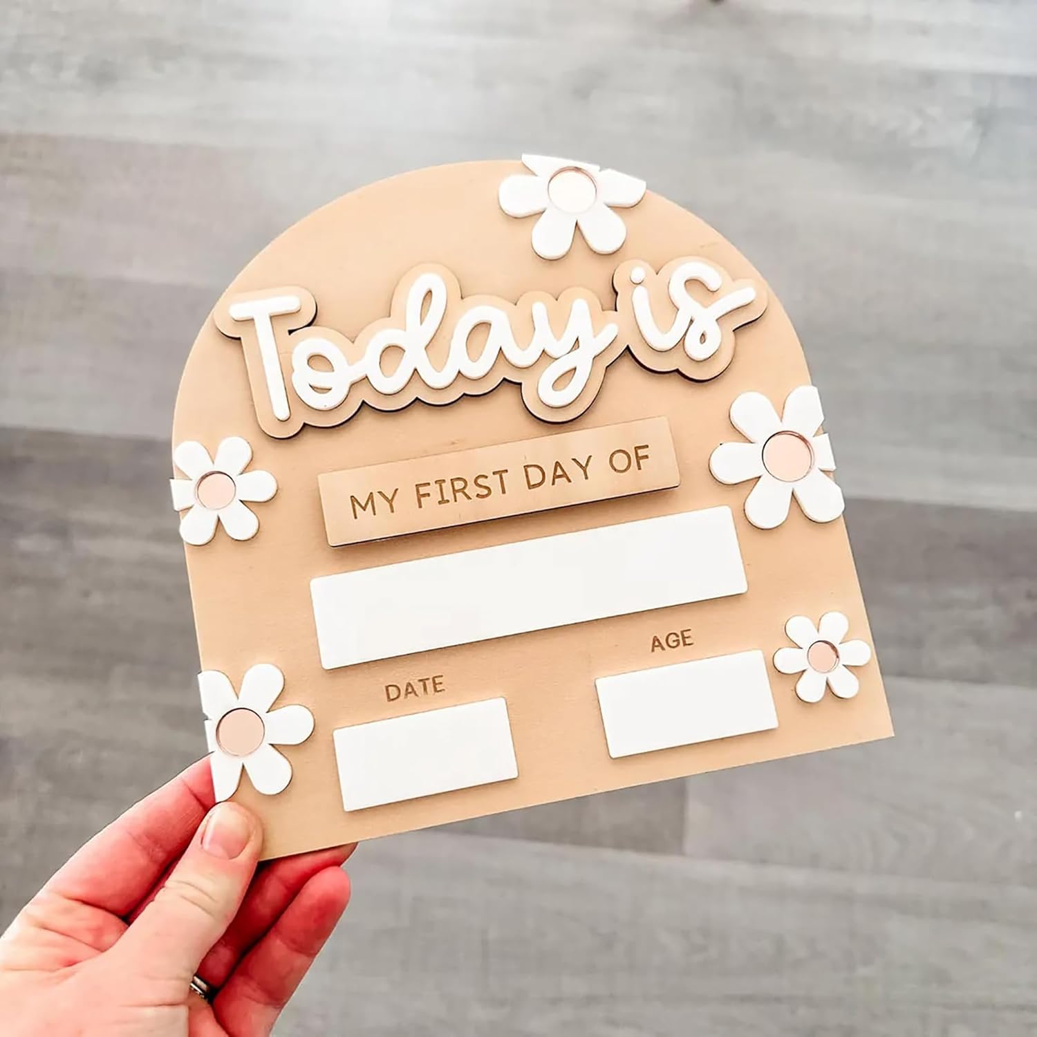Card with 'Today is my first day of' text and space for date and age on a wooden background