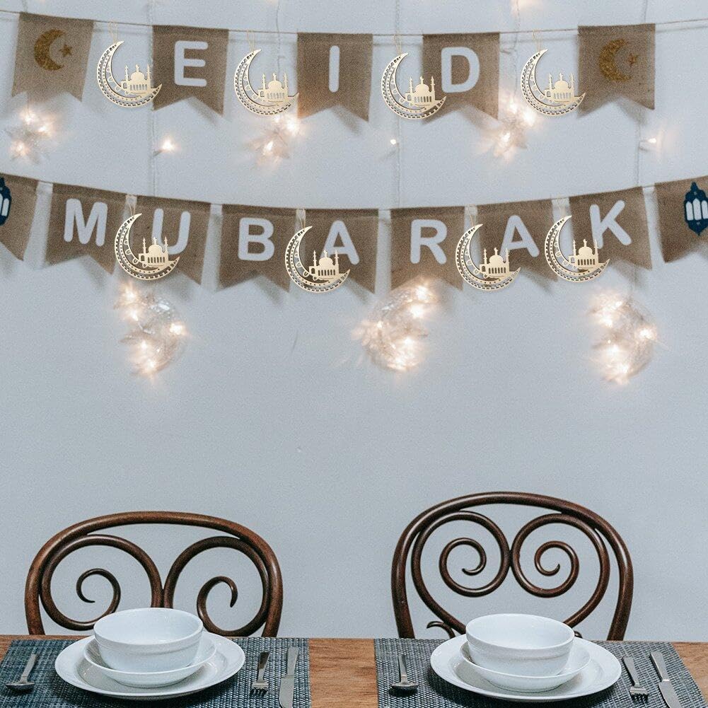 Dining table setting with 'Eid Mubarak' banner and decorative lights on a white wall.