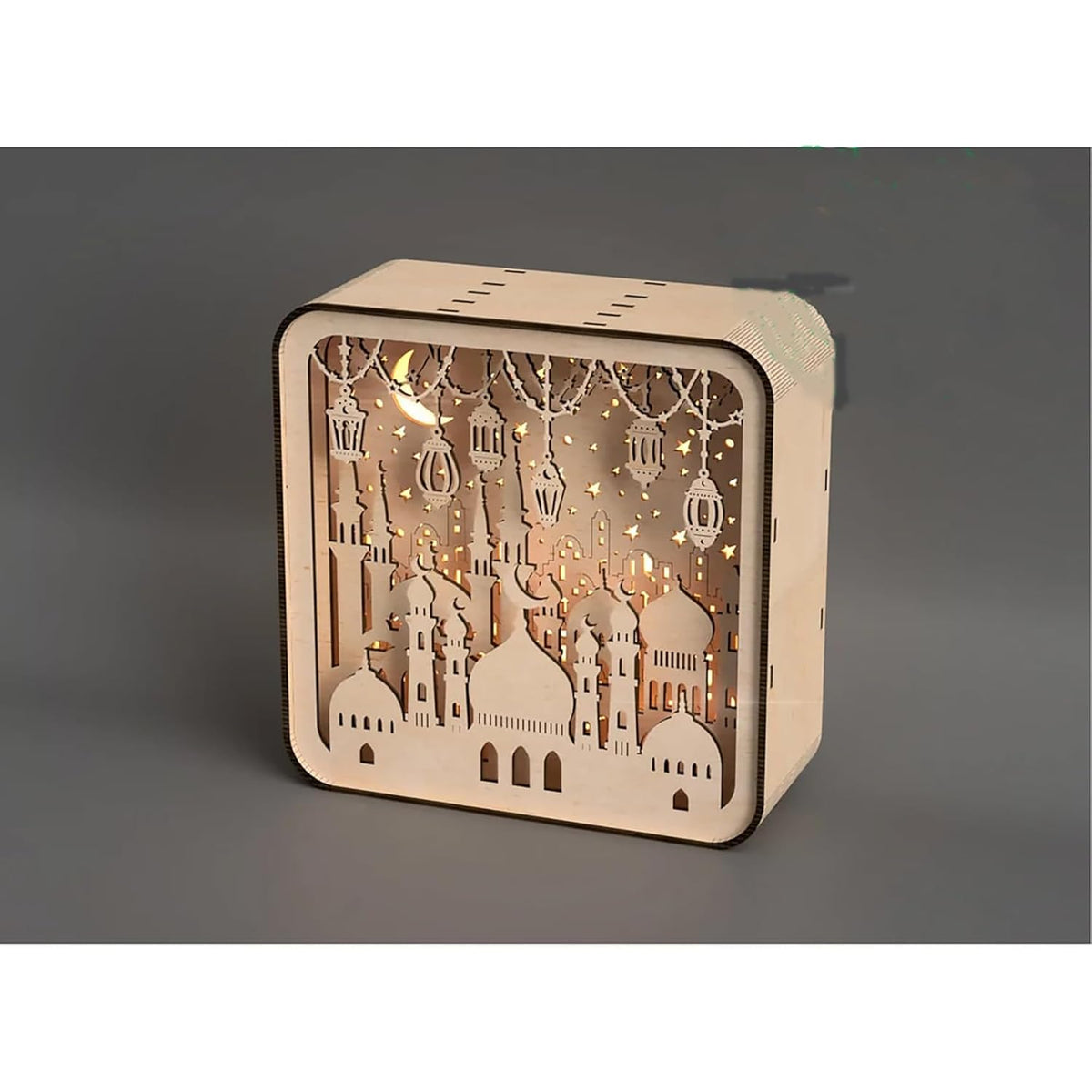 Wooden decorative box with cut-out designs and LED lights on a gray background