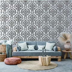 Living room with gray sofa, patterned wallpaper, and decorative items.
