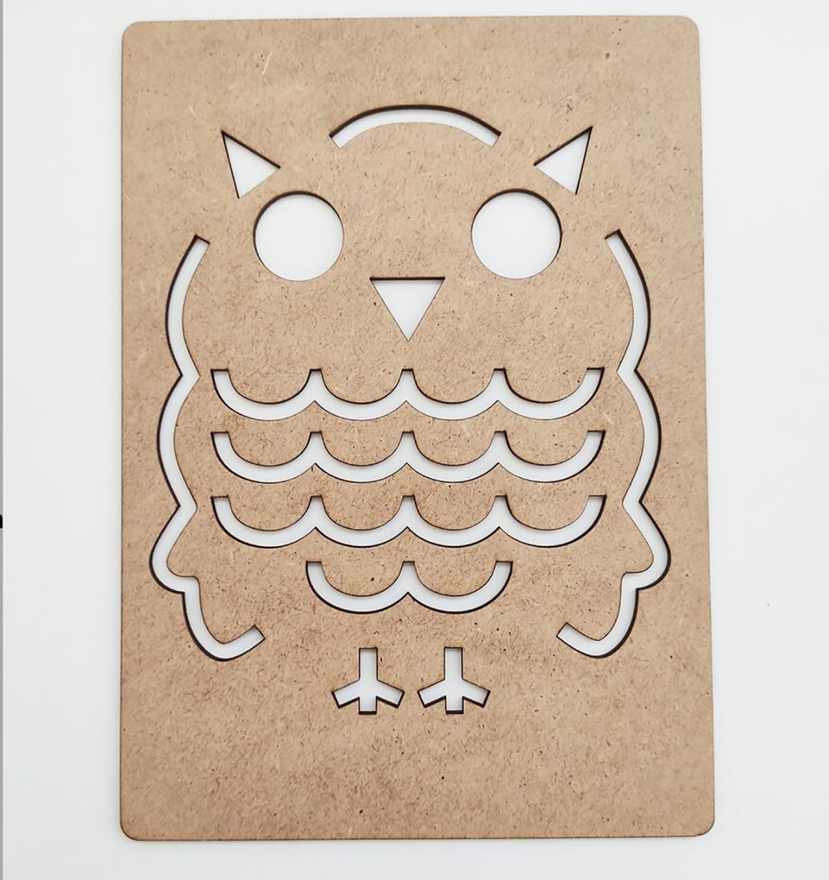 Cardboard cutout of an owl design on a white background