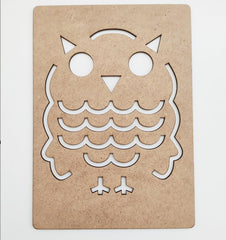 Cardboard cutout of an owl design on a white background